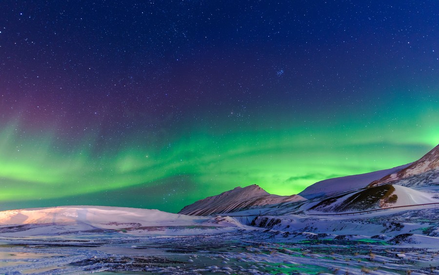 Aurora Borealis Over Snowy Peaks