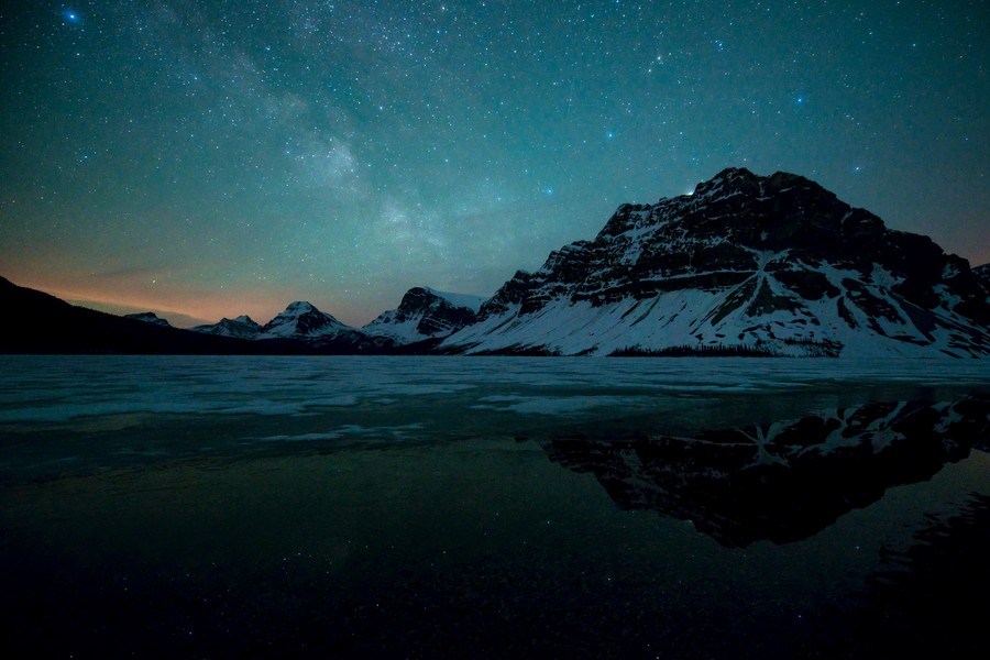Celestial Night: Whispers of Dawn Over Frozen Reflecting Waters