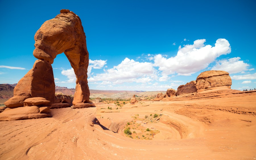 Desert's Grandeur: A Symphony of Red Sand and Towering Arches