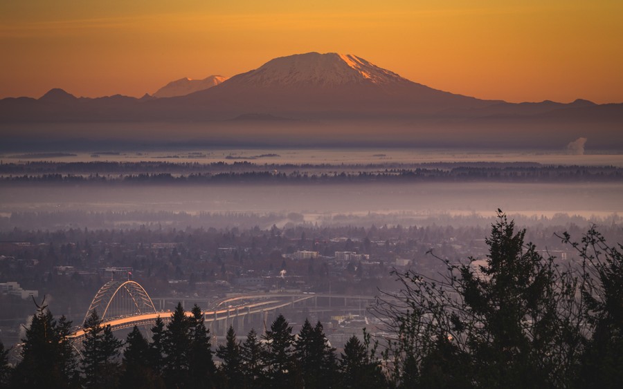 Eternal Glow: Golden Hour Over Cityscapes and Snowy Peaks