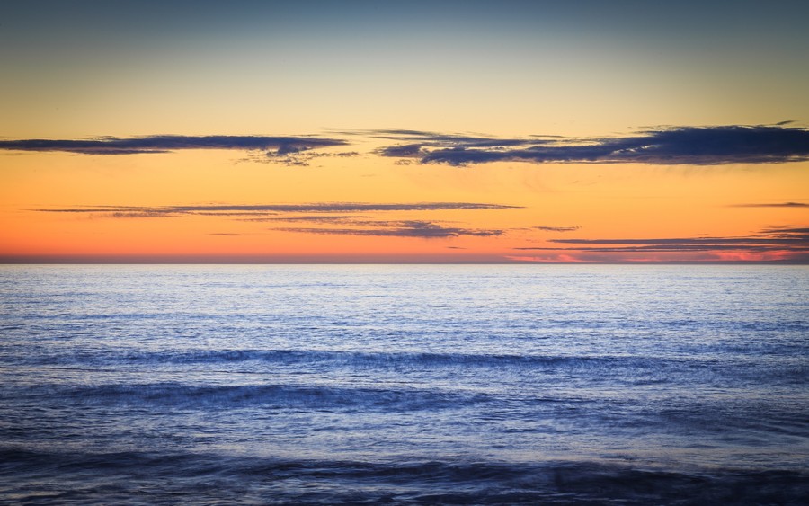 Ethereal Oceanscape: A Serene Sunset Over the Timeless Sea