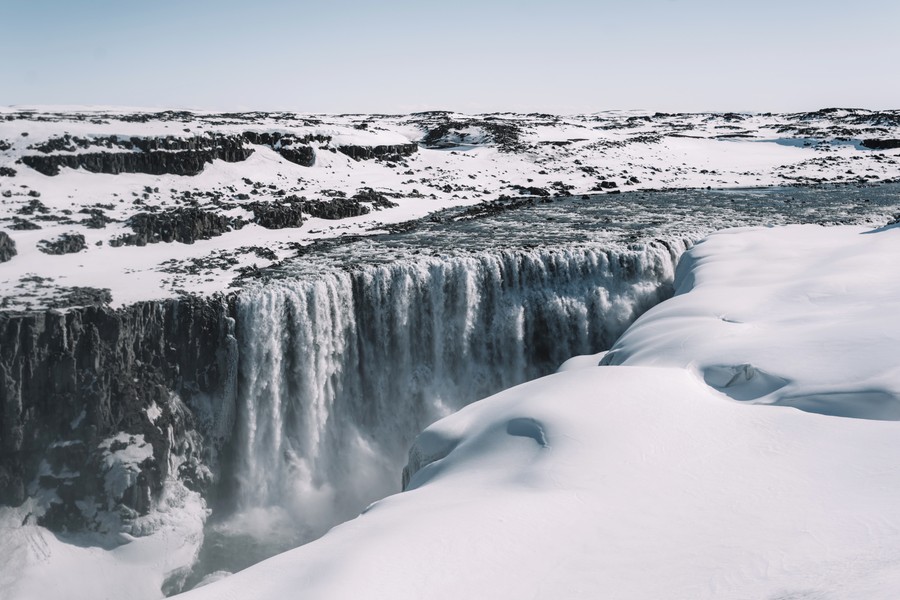 Frozen Majesty: A Winter's Embrace of Cascading Waterfalls