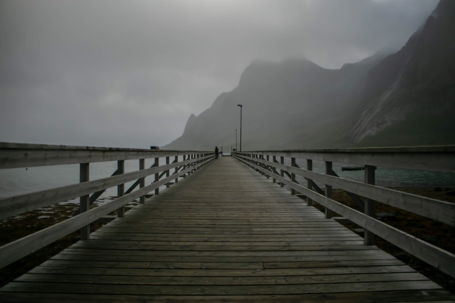 Lonely Solitude: A Wooden Pier Toward Misty Mountains