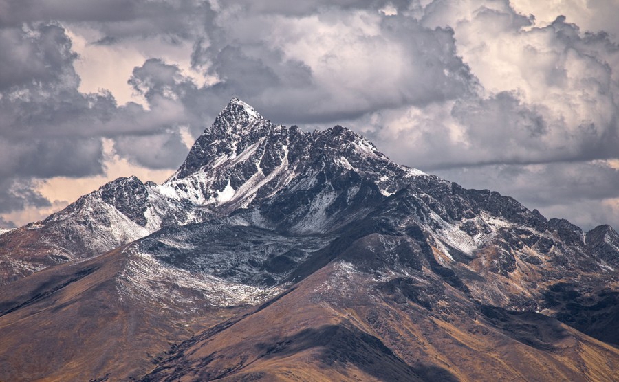 Majestic Peaks Under Stormy Skies: A Dramatic Mountain Landscape