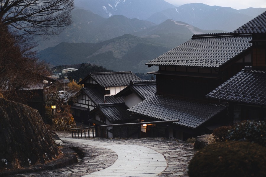 Misty Serenity: Traditional Japanese Homes Along a Cobblestone Path at Dawn