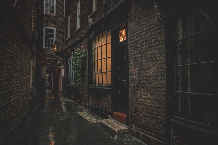 Nocturnal Urban Elegance: A Glimpse Down a Rain-Slicked Alleyway