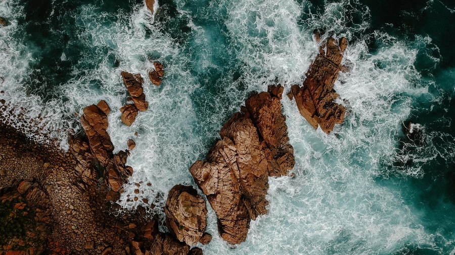 Powerful Ocean Waves Collide with Towering Rocky Cliffs