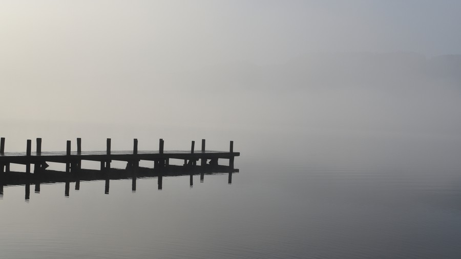 Silent Repose: Mist-Kissed Wooden Dock at Dawn
