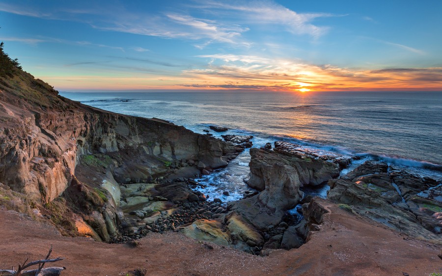 Awakening Horizons: Sunrise Over Rugged Coastal Cliffs
