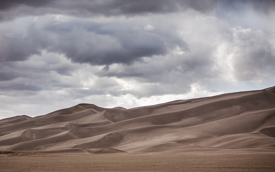 Timeless Dunes: Where Earth Meets a Moody Sky