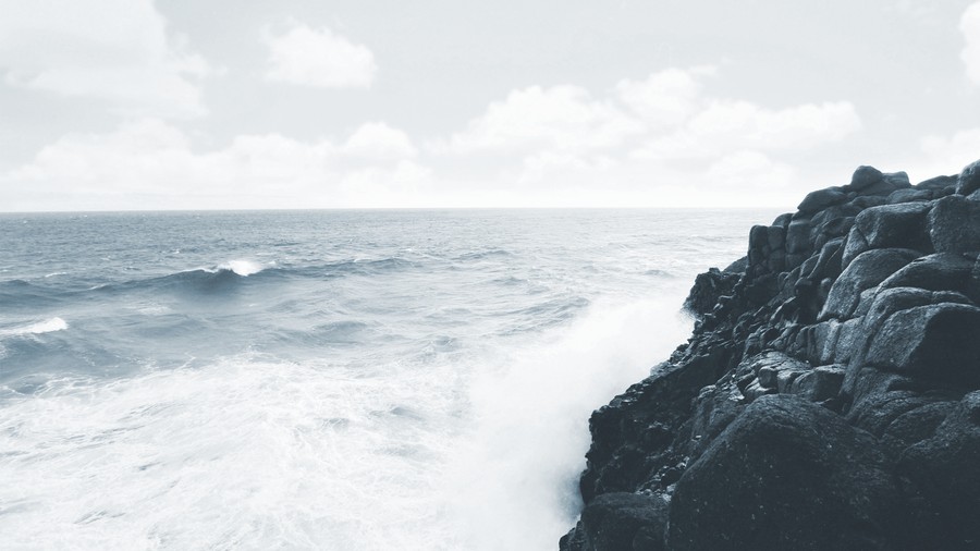 Tumultuous Tides: Clashing Waves Against Rugged Coastal Cliffs