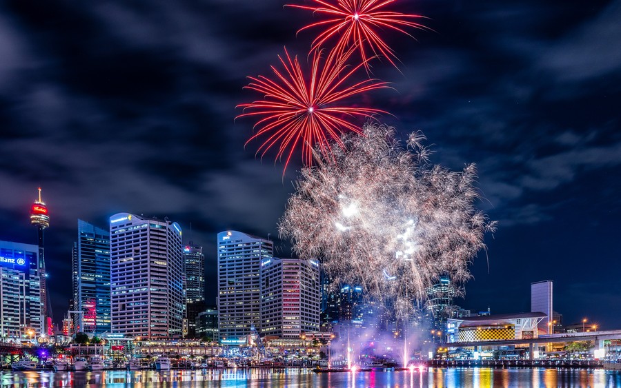 Vibrant Illuminated Metropolis: Fireworks Light Up the Urban Night